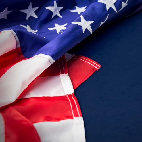 A U.S. flag folded over a navy blue background.